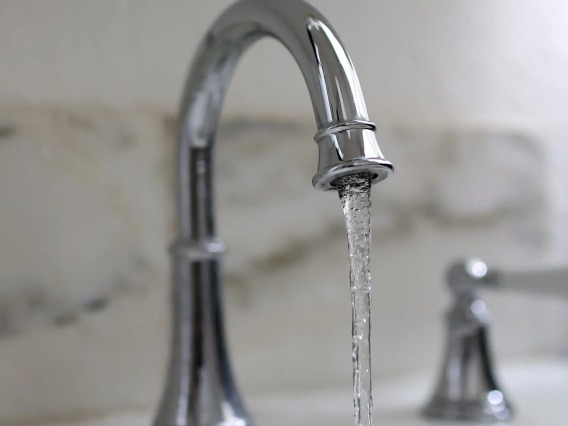 A stock image of a water faucet
