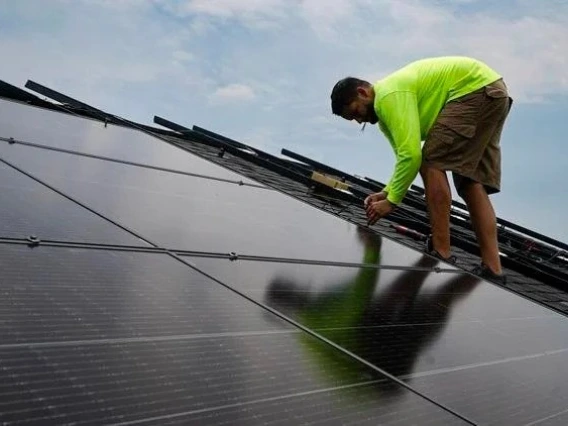 An image of a solar panel installer