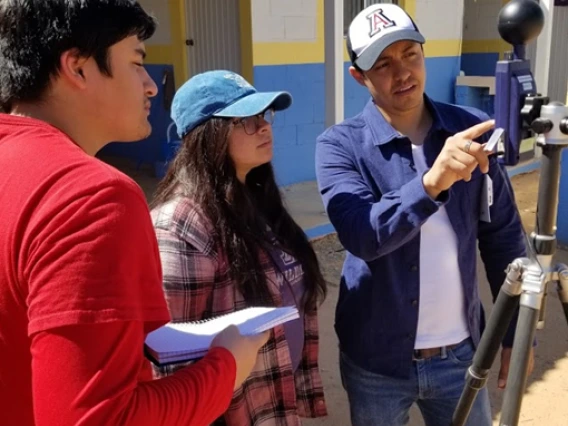 An image of a UA researcher training two staff members.