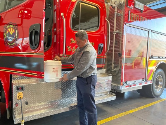 An image of a firefighter handling chemicals