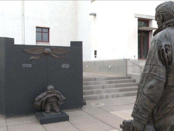 A statue of a firefighter outside a fire station 