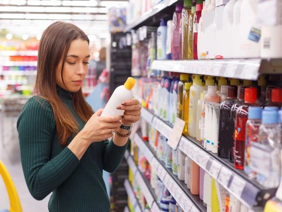 Store aisle with personal care products and brunette