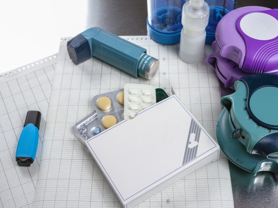 A stock image of an inhaler and other medicines