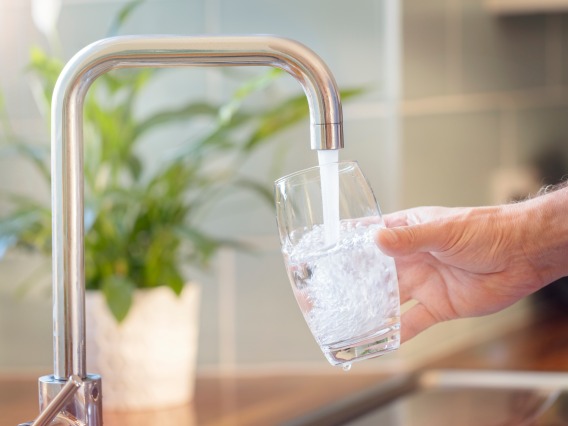 A stock image of a glass being filled with tap water