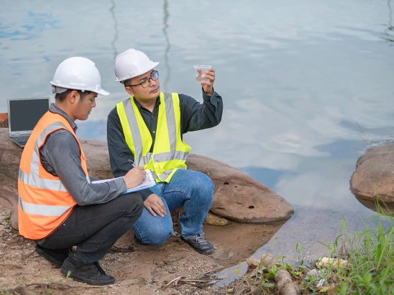 Two people analyzing water quality