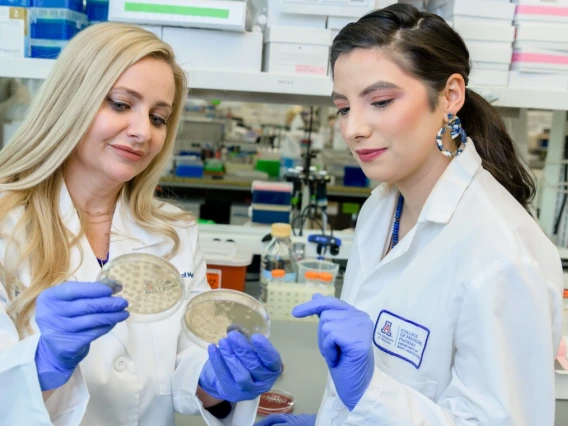 From left, Melissa Herbst-Kralovetz and Nicole Jimenez work in the Herbst-Kralovetz lab.