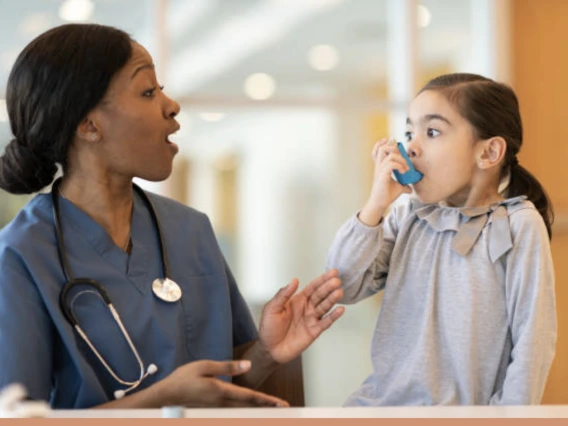 Image of a child using an inhaler.