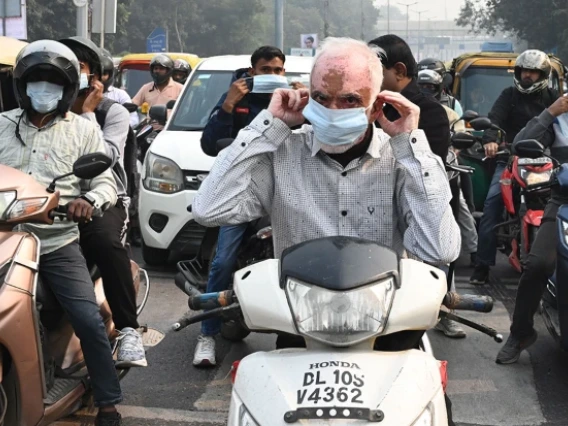 picture of people on mopeds in traffic