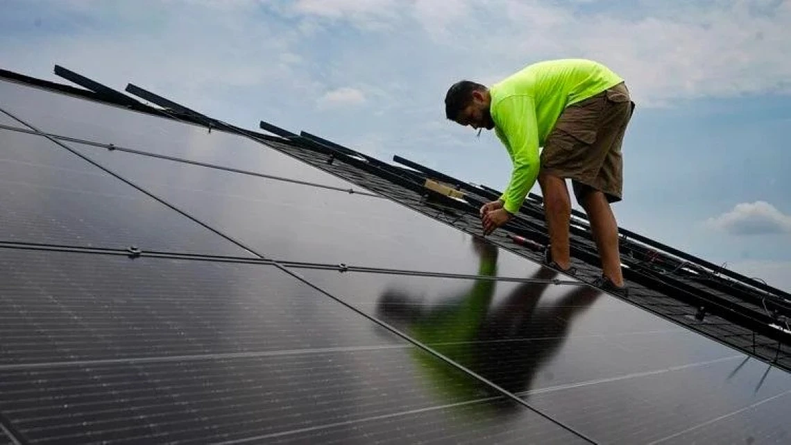 An image of a solar panel installer