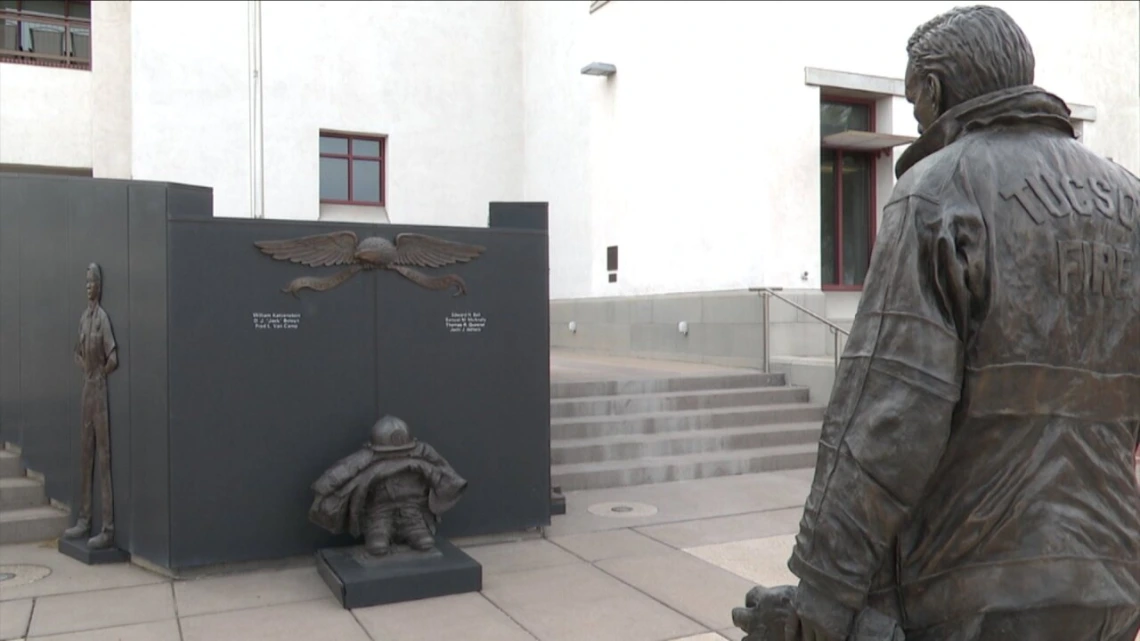 A statue of a firefighter outside a fire station 