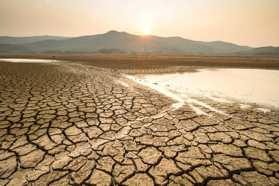 Landscape with cracked mud and drying lake bed