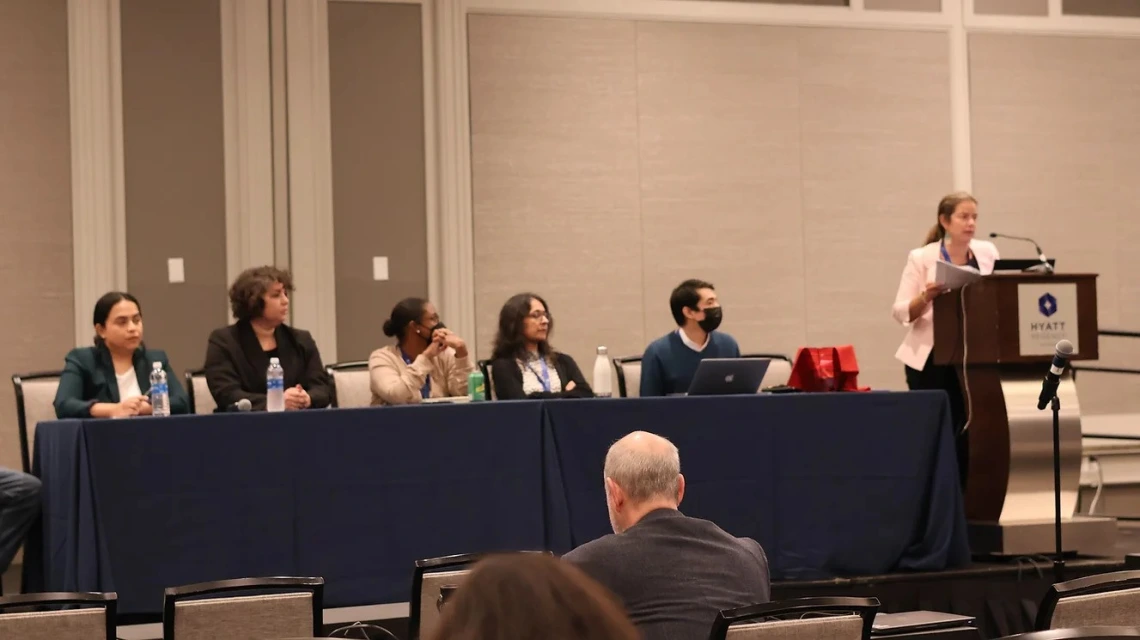 A picture of a panel of researchers at a conference 