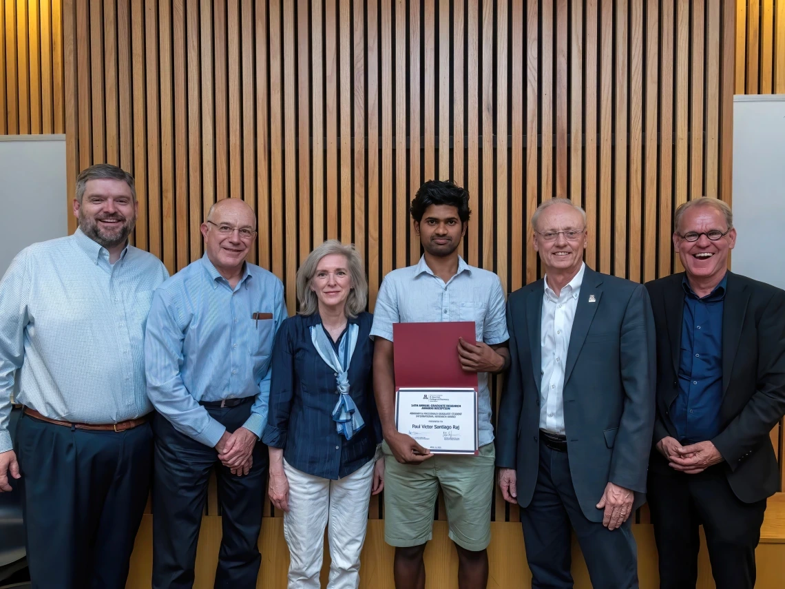 Image of Dr. Cherrington and people receiving awards