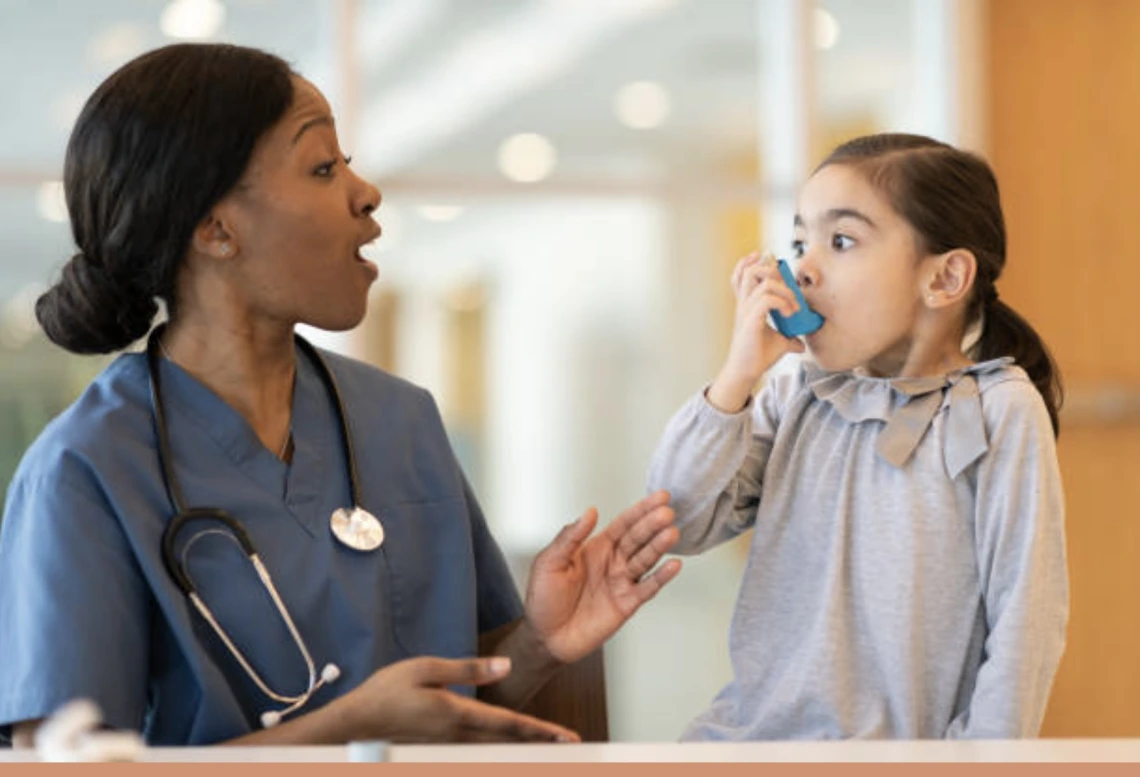 Image of a child using an inhaler.