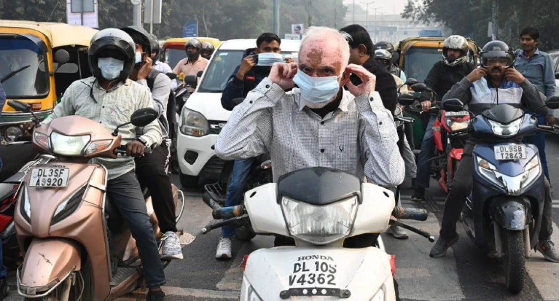 picture of people on mopeds in traffic