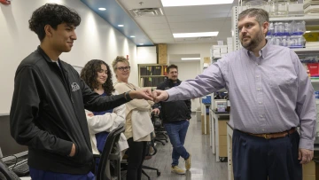 Nathan Cherrington, PhD, discusses research in his lab with JTED students.