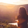 Image of a woman next to a sunset