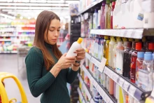 Store aisle with personal care products and brunette