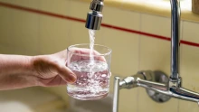 A glass being filled with water